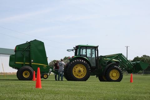 Adult trainer and student at tractor certification course.