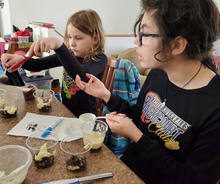 Two girls doing at-home 4-H activity
