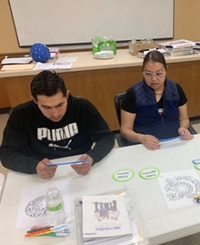 Two program participants working on a craft activity