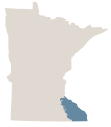 Map of Minnesota in gray with the extreme southeast region of Minnesota commonly referred to as the Driftless Area colored blue-gray.