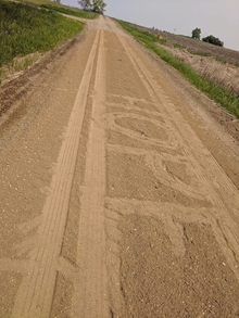 HOPE written between car tracks on a country dirt road.