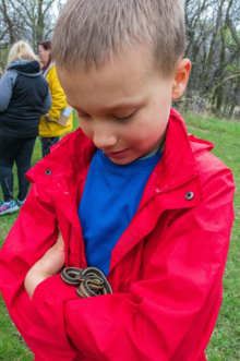 boy holding a snake