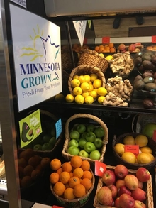 MN Grown sign all wall in front of many baskets of fresh produce