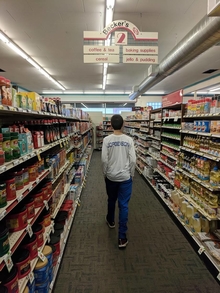 Man walking down the isle in a grocery store