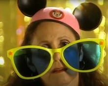 Mom wears Disney mouse ears and giant sunglasses to try to be the most fun parent.