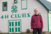 Sue Craig in front of a 4-H building