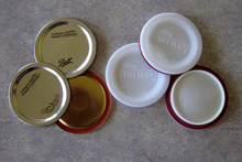 Two different types of canning lids. Three metal lids on the left and three Tattler-brand lids on the right.