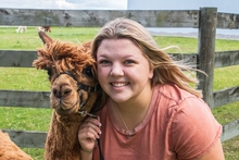 Ella Hanson and a brown llama