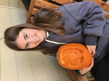 Girl holding pumpkin carved into 4-H clover
