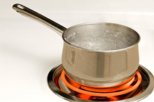 Pot of boiling water on the stove.