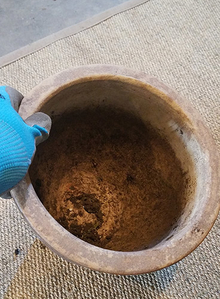 Inside of ceramic pot with soil debris