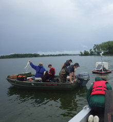 Researchers in boat on lake