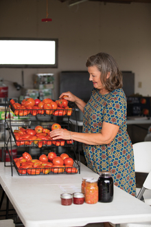Woman arranging tomatoes in a display stand