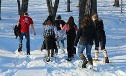 4-H youth snowshoeing in the woods