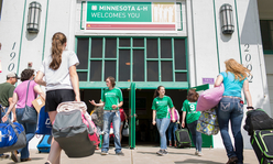 Youth coming and going at the entrance of the 4-H building at the Minnesota State Fair.