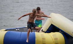 kid jumping off water trampoline