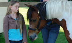 girl looking at horse