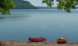 Kayaks on beach at lake.