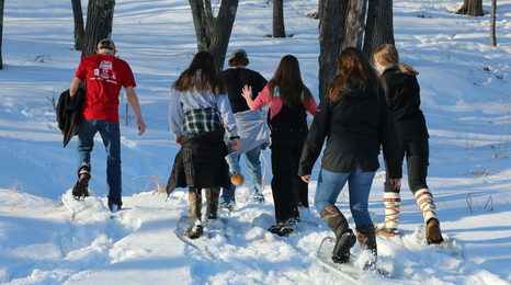 kids snowshoeing in woods