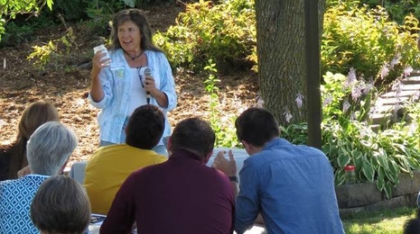 A woman giving an outdoor talk. 