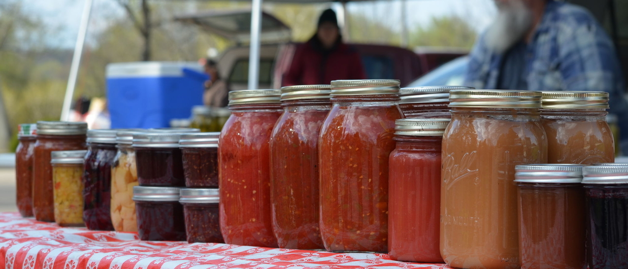 Food in jars for sale at farmers market.