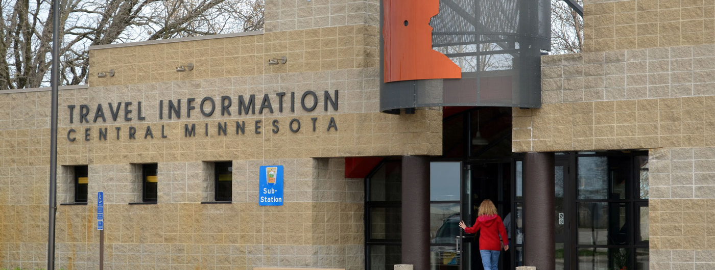 Person opening the door to the Travel Information Center in Central, Minn.