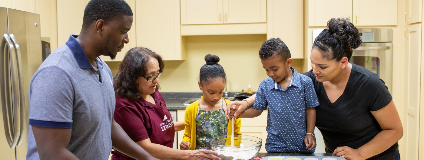 A nutrition educator works with a family