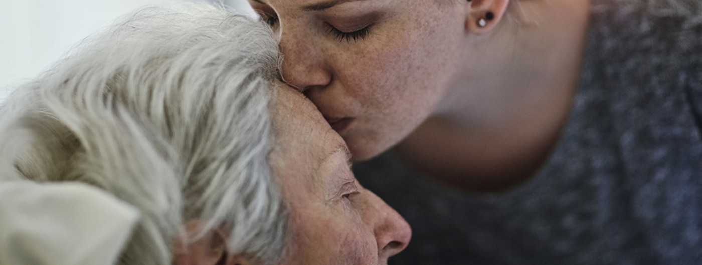 Woman kissing grandmother