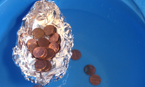 pennies in a tin foil boat