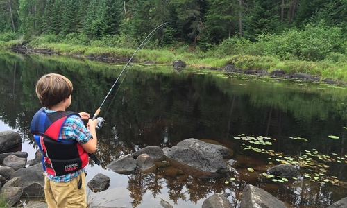 boy fishing in river