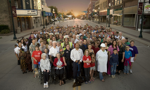 Small town community members representing diverse backgrounds and professions gather together on their Main Street.