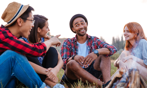 Diverse group of millennials sitting outdoors