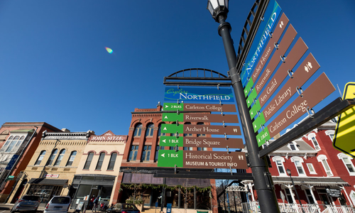 Street signage with tourism markers for visitors in Northfield, Minnesota.