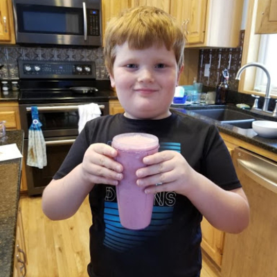 Boy holding a smoothie.