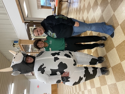 Group of 3 youth, one in cow costume