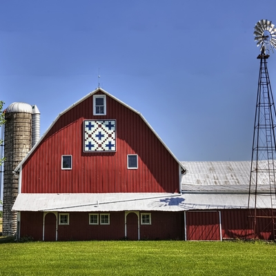 Dairy barn, silo and windmill on a farm