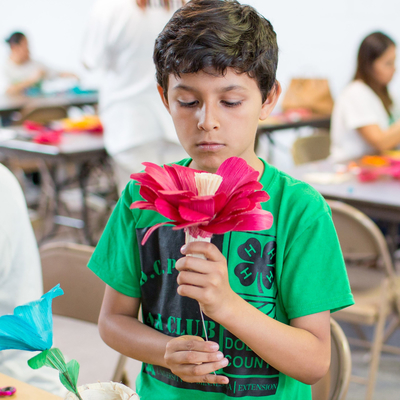 Chris Pulido working on a paper flower craft.