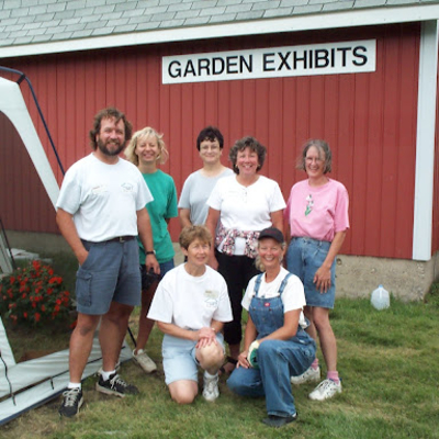 Cobus Family standing by fair garden exhibit building