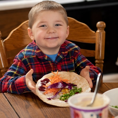 preschooler with veggie tortilla and yogurt mustache