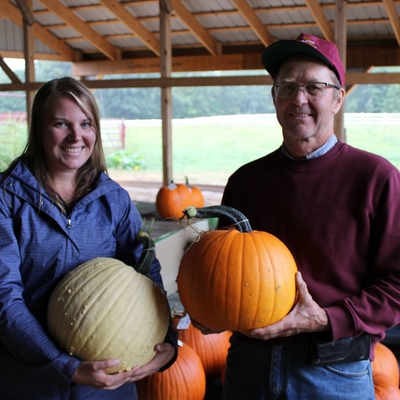 Annie Klodd and Rod Elmstrand holding pumpkins