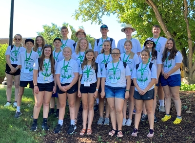 A group of youth wearing matching 4-H camp shirts