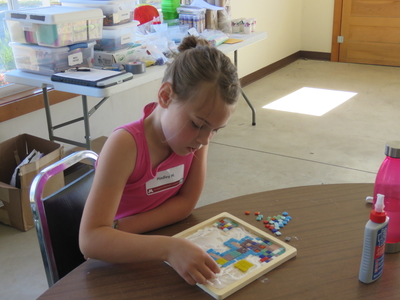 4-H youth working on tile mosaic project at 4-H camp