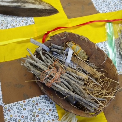 traditional Indigenous healing bowl with twigs