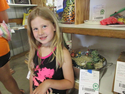 Young girl standing by 4-H project