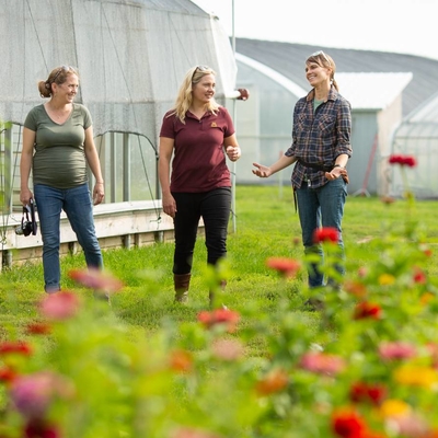 Women farmers outside greenhouses