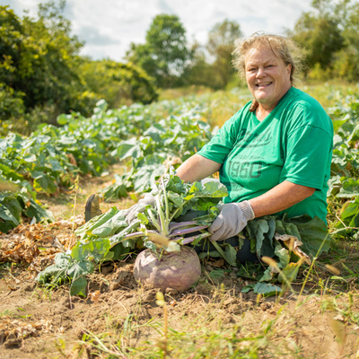 Farmer Rae Rusnak sitting in a field of turnips.