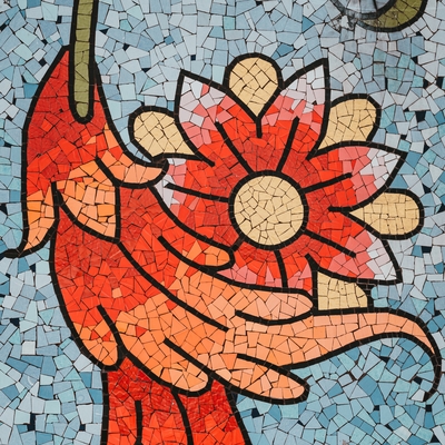 A mosaic of a red flower with a blue background.