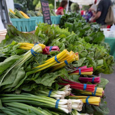 chard and green onions on table at market