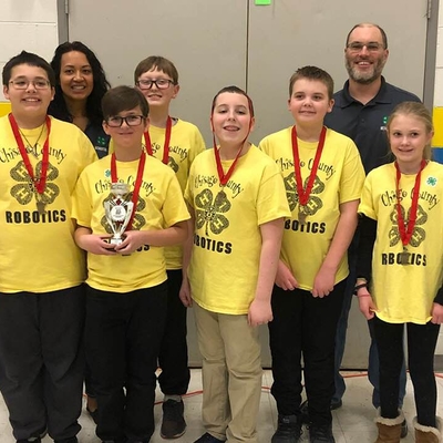 4-H Chisago County robotics team posing with ribbons and a trophy.