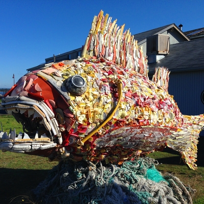 A giant fish sculpture made out of recycled plastic